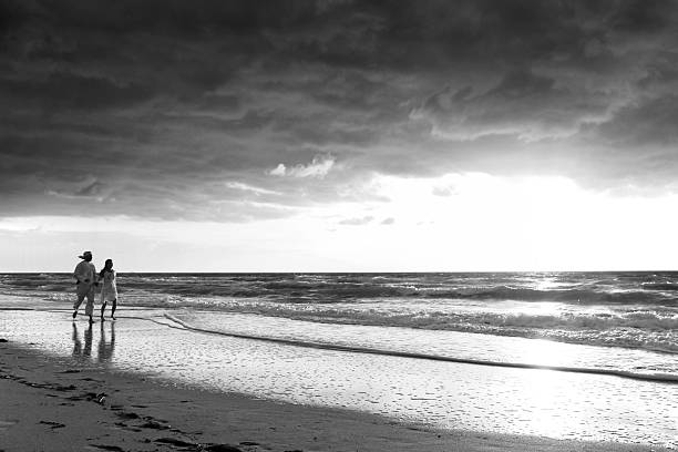 istock Couple walking on the beach 182785042