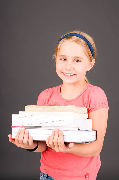 Young child with school books stock photo