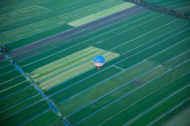 Hot air balloon fully inflated after landing on field
