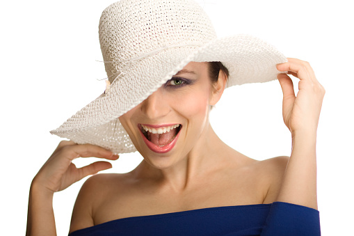 Portrait of a happy young woman in white hat. Isolated on white background.