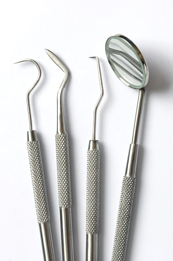 Group of precision dental tools isolated on white.