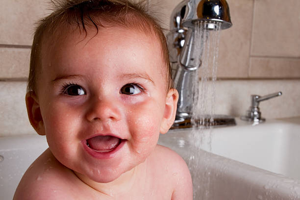 istock Cute Baby Boy Bathing in Kitchen Sink 182787074