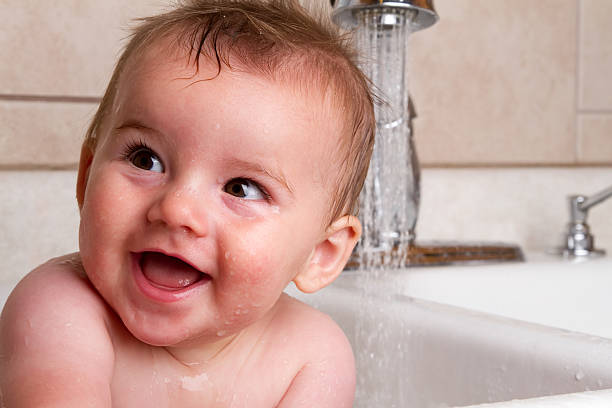 istock Cute Baby Boy Bathing in Kitchen Sink 182787629