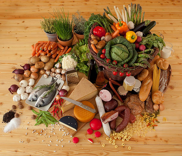 variegated foodstuff topview "wide range of cheese, sausages, bread and vegetables on wooden table topview" basket healthy eating vegetarian food studio shot stock pictures, royalty-free photos & images