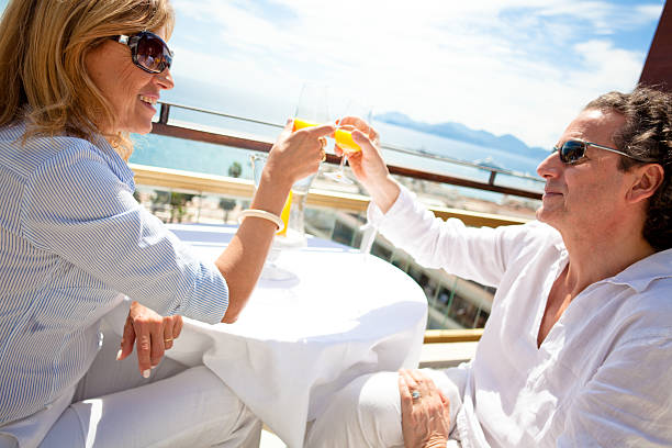 istock Happy couple drinking mimosas on a penthouse balcony 182787850