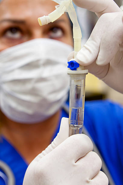 istock Surgical Nurse Prepares IV Drip 182788068