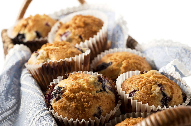 Close-up of blueberry muffins in rectangular basket SEVERAL MORE IN THIS SERIES. Basket of homemade blueberry muffins. Very shallow DOF. Blueberry Muffin stock pictures, royalty-free photos & images