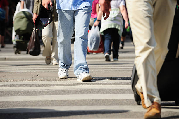 istock People walking on zebra crossing with bag 182788919