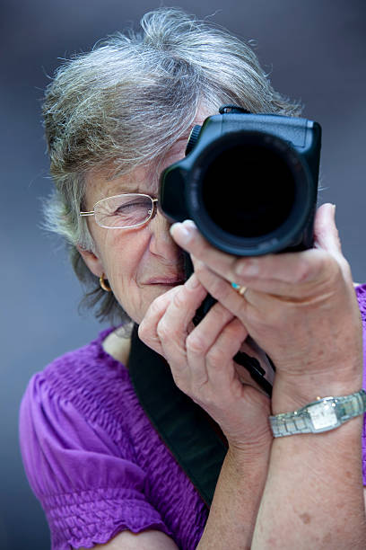 istock senior photographer with nice digital slr camera 182788950