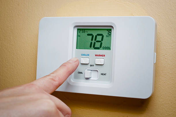 Setting thermostat Setting thermostat to 78 degreeMore object images: fahrenheit stock pictures, royalty-free photos & images