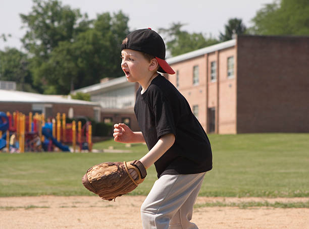 istock Boy Playing Baseball in a School Yard 182789536