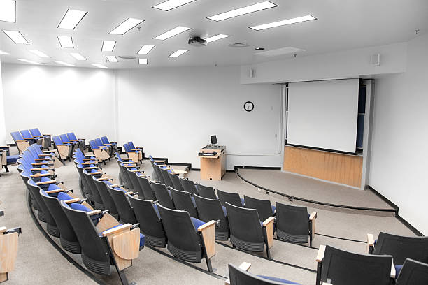 Lecture Hall An empty modern college classroom. empty desk in classroom stock pictures, royalty-free photos & images