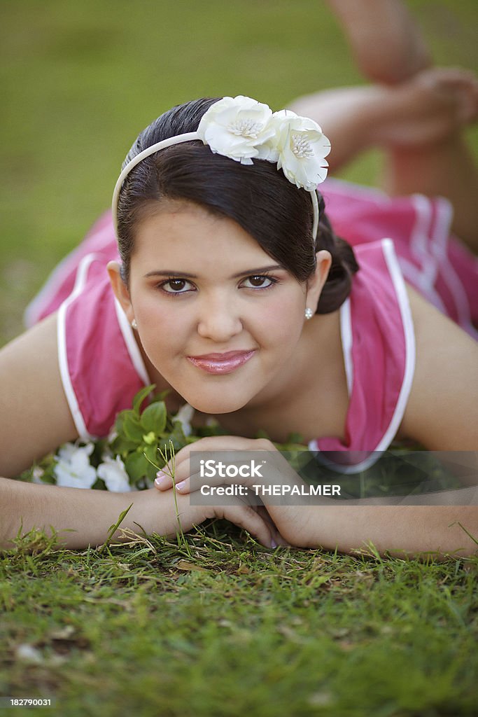 girl laying in the grass girl laying in the grass posing during her quiceanera shooting. (the sweet 16 for latin girls) 16-17 Years Stock Photo