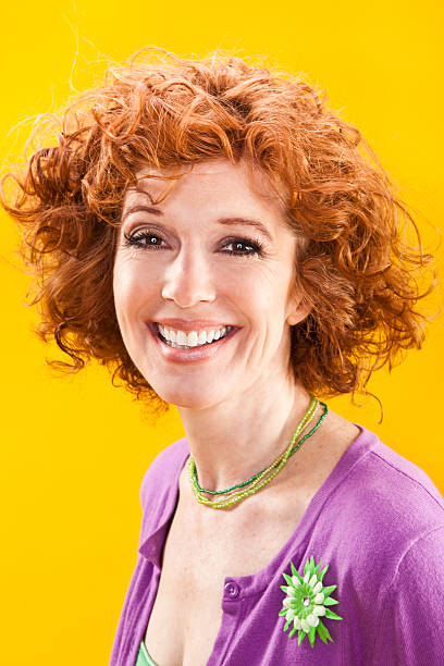 Beautiful Mature Redhead Woman on Yellow Background