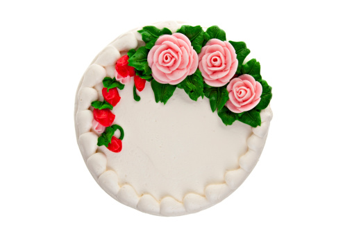 Overhead view of decorated cake on a white background.