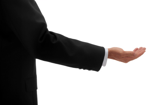 This is a photo of a businessman holding out his hand isolated on a pure white background. This image could relate to looking for a handout or you could place something in his hand.Click on the links below to view lightboxes.