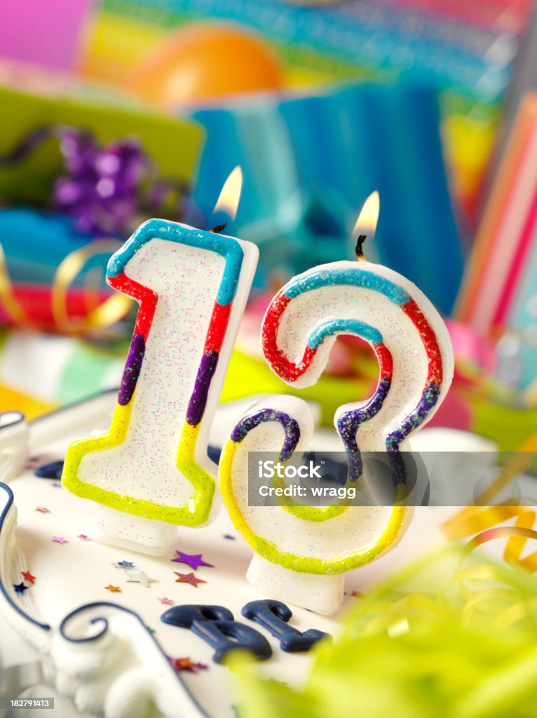 Number Thirteen Birthday Candle Number thirteen birthday candle with differential focus on the gifts.Click on the link below to see more of my party and wedding images Birthday Cake Stock Photo