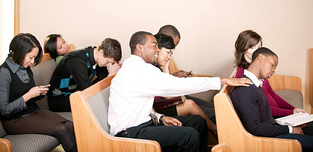 Boring sermon A group of people listening to a sermon in church - Buy credits multiple churches stock pictures, royalty-free photos & images