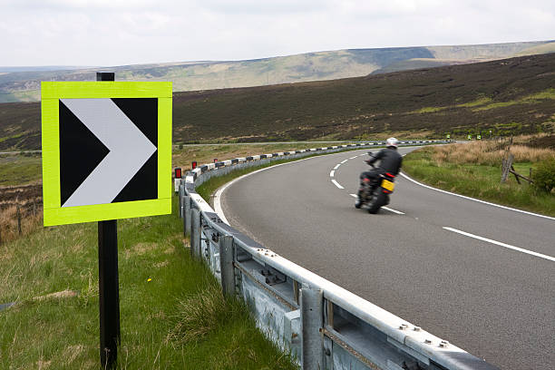 Fast bend with road sign and motorbike
