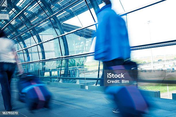 Blurred People Pulling Suitcase At An Airport Stock Photo - Download Image Now - Adult, Airport, Airport Departure Area