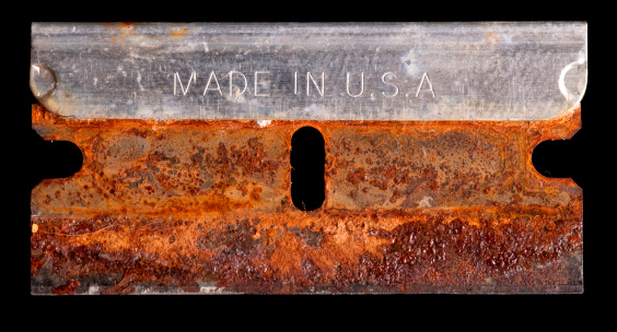 Rusty razor blade isolated on a black background. Includes clipping path.