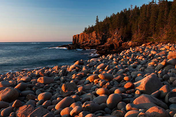 istock Golden Sunrise Glow on Round Beach Rocks 182793369
