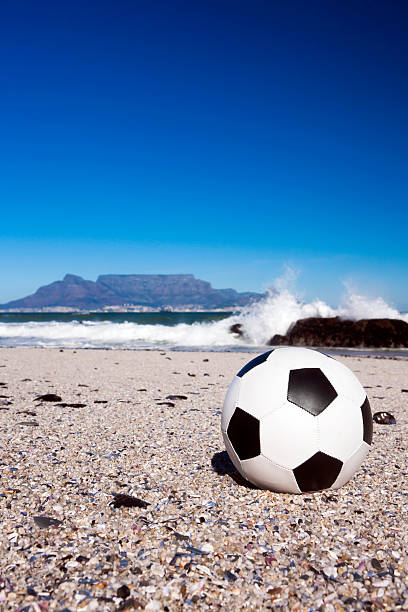 istock Soccer ball on shingle beach in front of Table Mountain 182793673