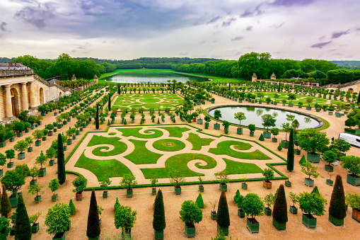 Versailles, France - May 2019: Versailles formal gardens (Orangery) outside Paris at sunset
