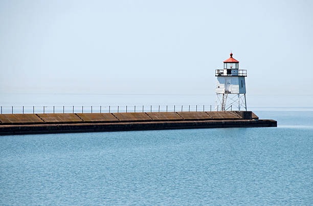 istock Lighthouse at entrance to harbor 182794431