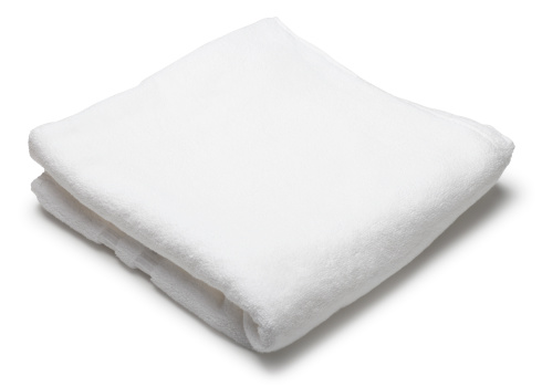 A folded white towel on a white background. Clipping path included.