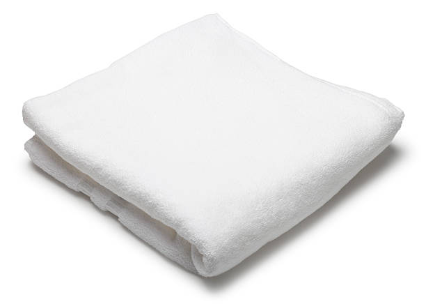 Folded white terrycloth towel on white background A folded white towel on a white background. Clipping path included. terry towel stock pictures, royalty-free photos & images