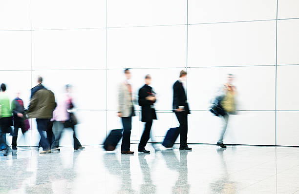 istock Pedestrians and Business Commuters Walking Down Hallway, Blurred Motion 182794699