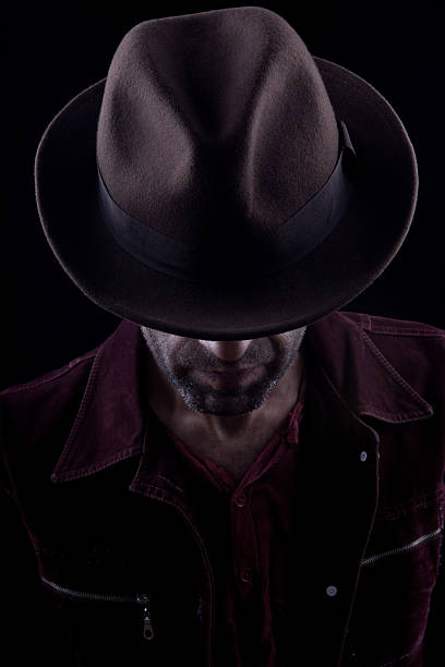 istock Obscured spooky face behind fedora 182794750