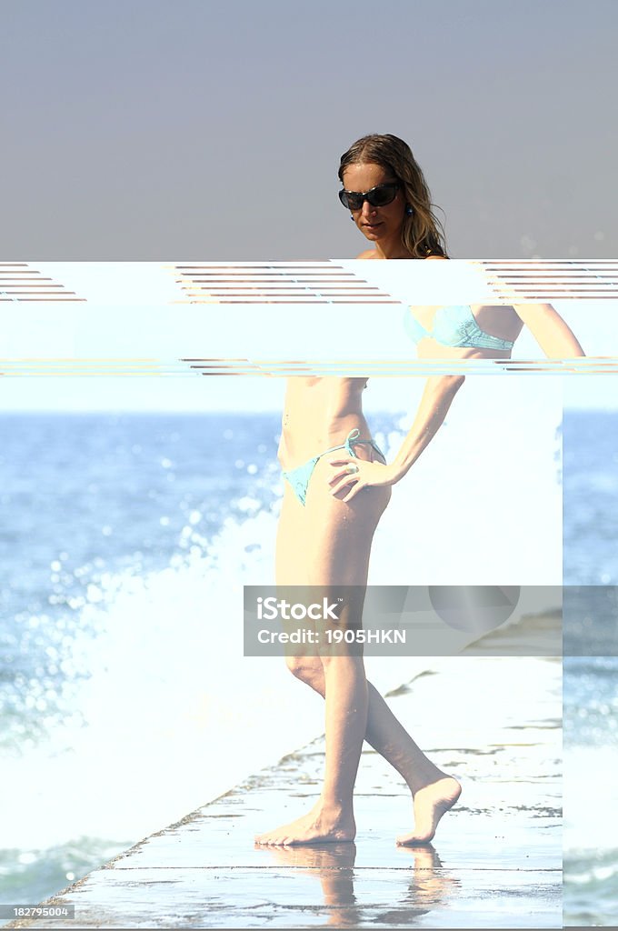 Summer Day photo of young woman standing on the beach. Adult Stock Photo