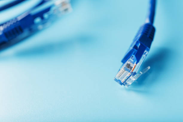 istock Blue UTP Internet Cable Isolated on a blue background Ethernet Cord 1827953616
