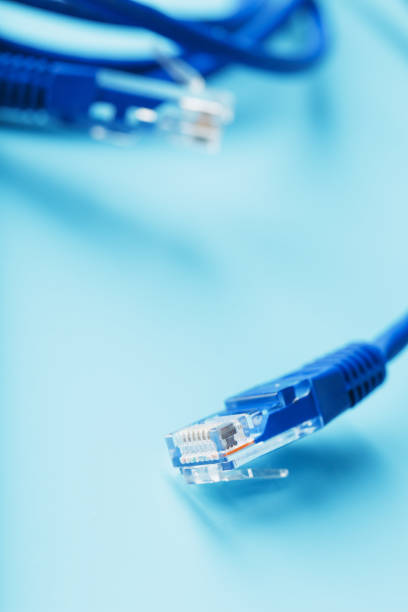 istock Ethernet Cable connector Patch cord cord close-up on a blue background with free space 1827955489