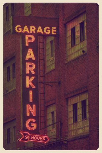 Retro-styled postcard of a parking garage in a non-descript urban environment.