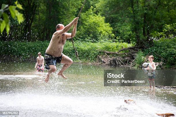 Man Swinging On Rope Swing Stock Photo - Download Image Now - Men, Rope Swing, Inflatable