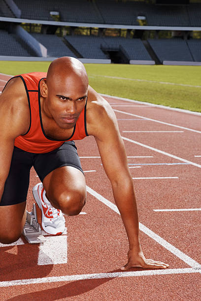 istock Athlete in start position on running track 182796055