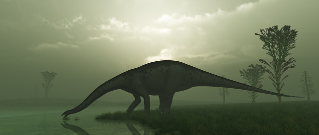 An Apatosaurus, also known as a Brontosaurus, drinking from a lake.