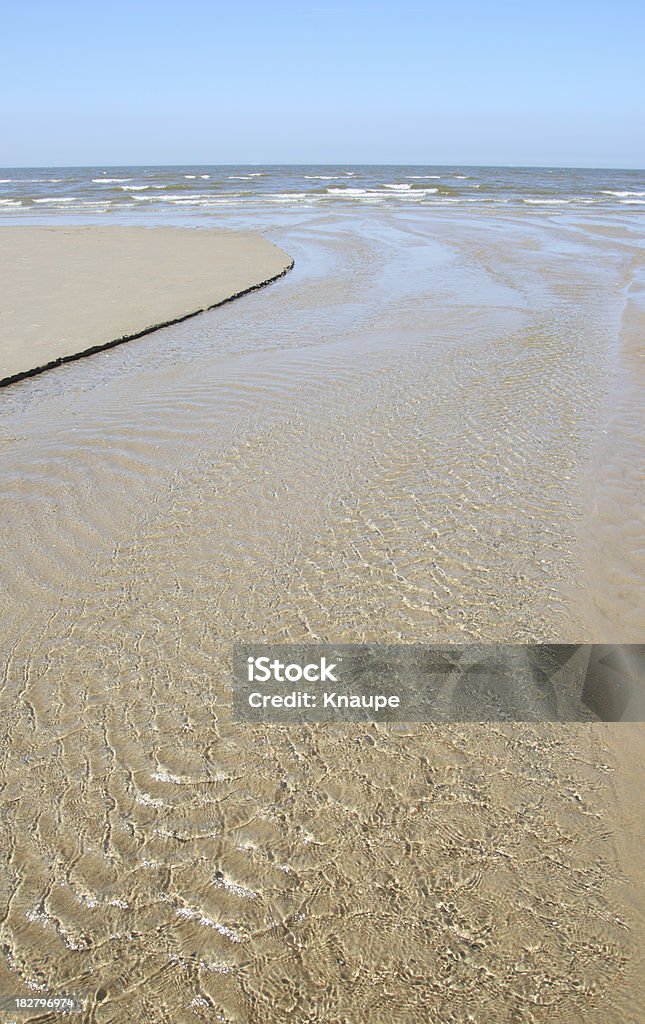 Flowing water on sandy beach at north sea Beach Stock Photo