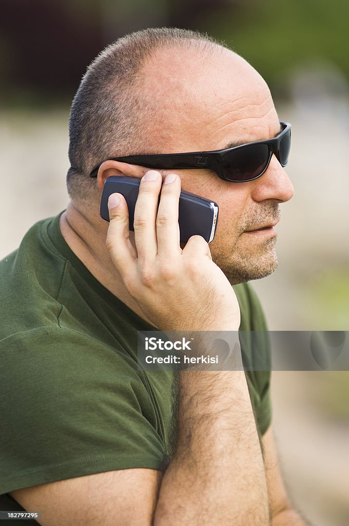 On The Phone Bald man on the phone 40-44 Years Stock Photo