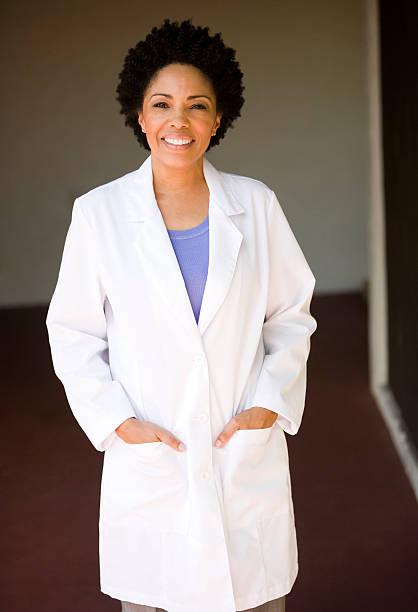 istock African descent female with lab coat hands in pockets 182797339