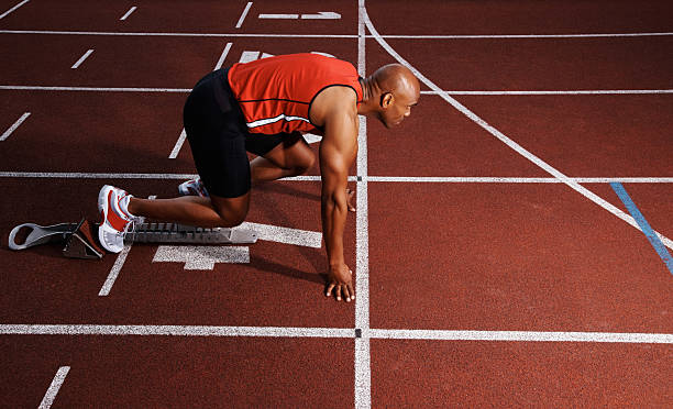 istock Male athletic in start position on track 182797645