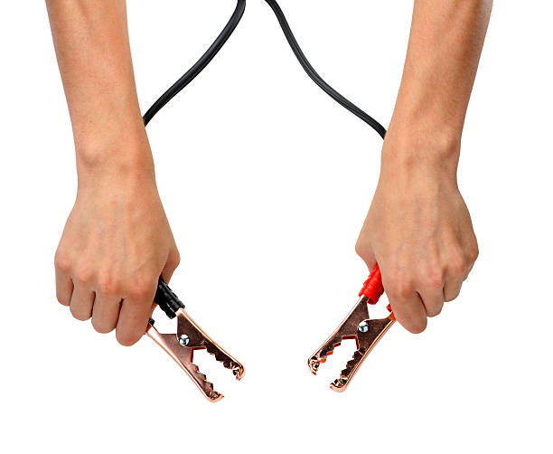 Jumper Cables A man holding jumper cables on white background. Clipping path included. jumper cable stock pictures, royalty-free photos & images