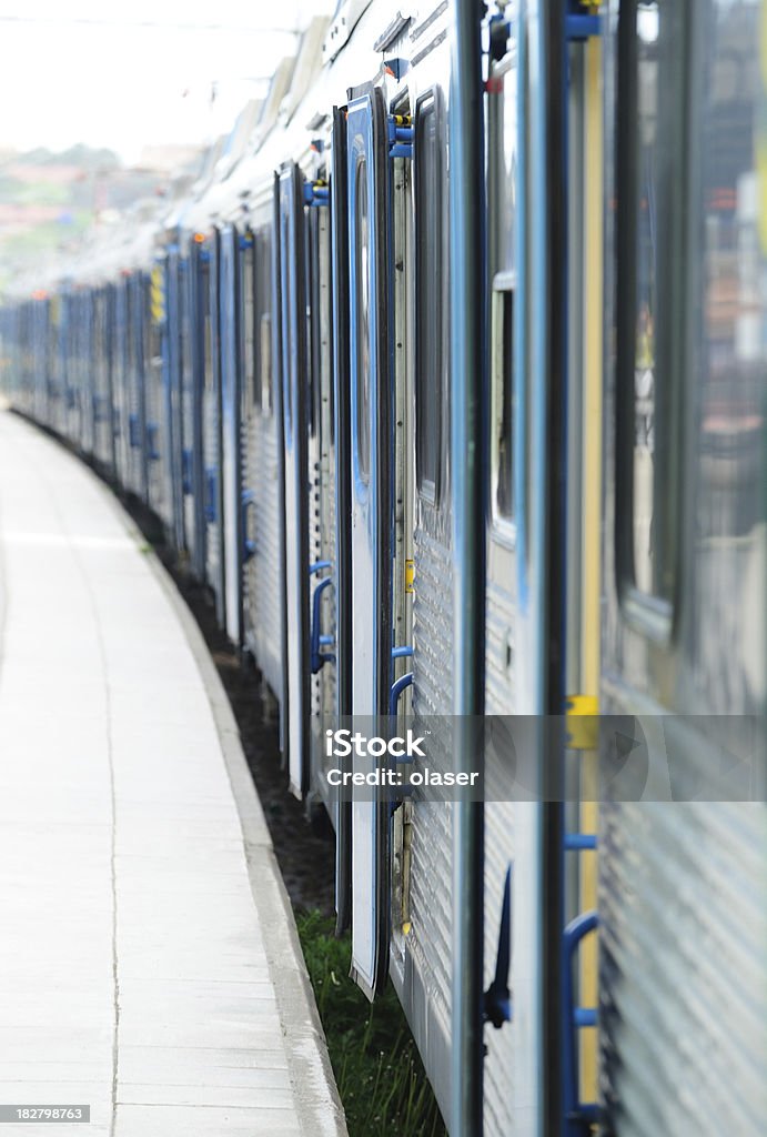 Commuter train mid day Daytime picture of train ready to depart. Doors are open. Glass reflection. Activity Stock Photo