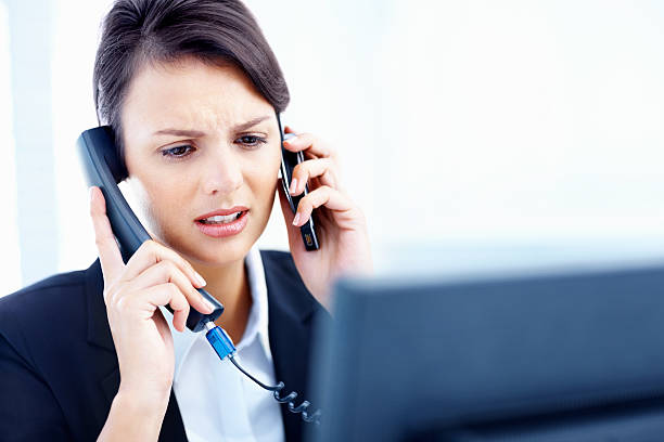 istock Busy busineswoman answering multiple calls 182798908