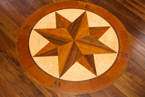 Custom hardwood floor with compass inlay.See more home related images: