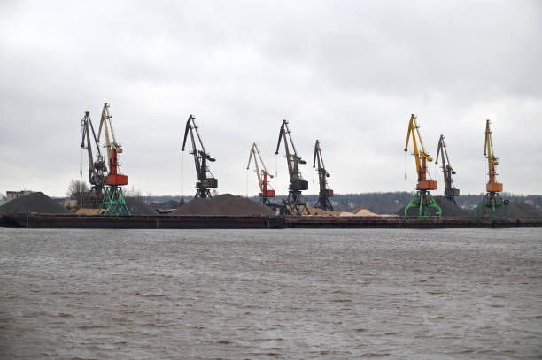 istock Loading, unloading of goods, bulk materials by cranes in river port 1827993509