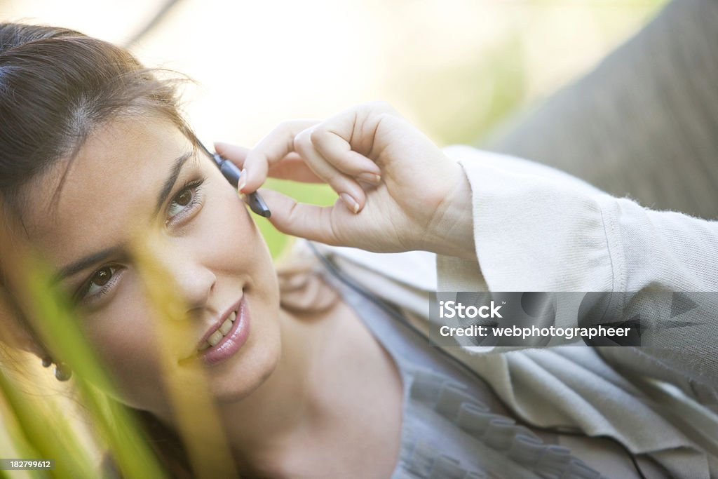 Woman using headset "Woman with blue tooth head set, canon 1Ds mark III" Adult Stock Photo